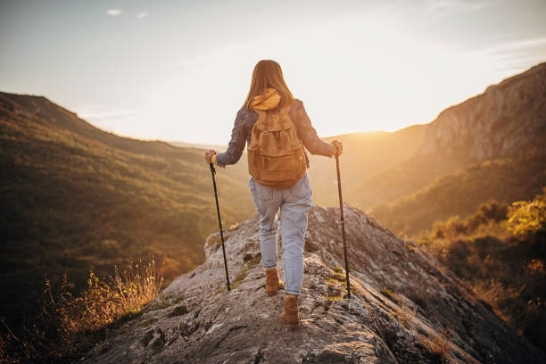 Woman on top of a mountain on a trekking trip