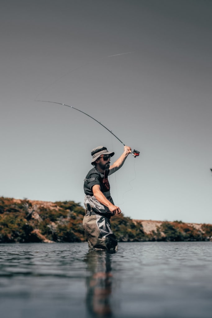 Man catching fish with a fishing rod
